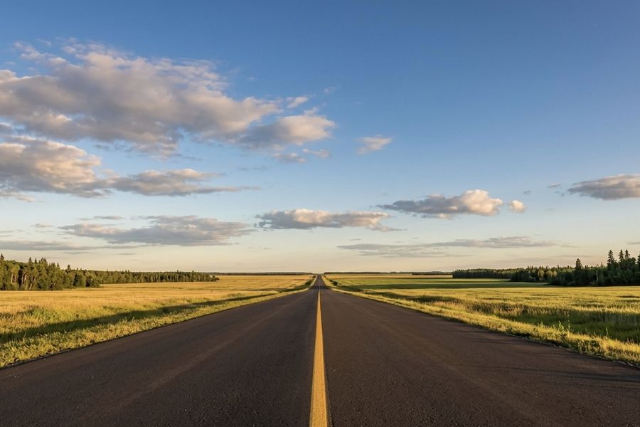 Empty northern Alberta highway stretching to the horizon near Grande Prairie